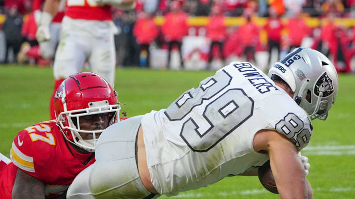 Nov 29, 2024; Kansas City, Missouri, USA; Las Vegas Raiders tight end Brock Bowers (89) scores a touchdown as Kansas City Chiefs safety Chamarri Conner (27) makes the tackle during the second half at GEHA Field at Arrowhead Stadium. Mandatory Credit: Denny Medley-Imagn Images