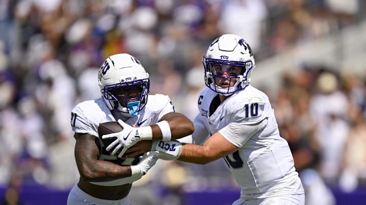 Sep 20, 2025; Fort Worth, Texas, USA; TCU Horned Frogs quarterback Josh Hoover (10) hands the ball off to running back Nate Palmer (21) during the game between the TCU Horned Frogs and the SMU Mustangs at Amon G. Carter Stadium. Mandatory Credit: Jerome Miron-Imagn Images