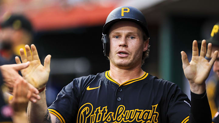 Jack Suwinski (65) high fives teammates after scoring on a RBI single. Jack Suwinski (65) high fives teammates after scoring on a RBI single.