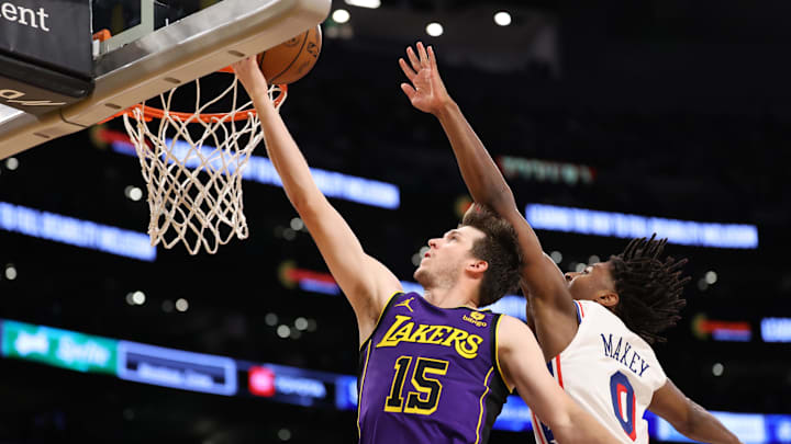 Mar 22, 2024; Los Angeles, California, USA;  Los Angeles Lakers guard Austin Reaves (15) goes to the basket against Philadelphia 76ers guard Tyrese Maxey (0) during the fourth quarter at Crypto.com Arena. Mandatory Credit: Kiyoshi Mio-Imagn Images