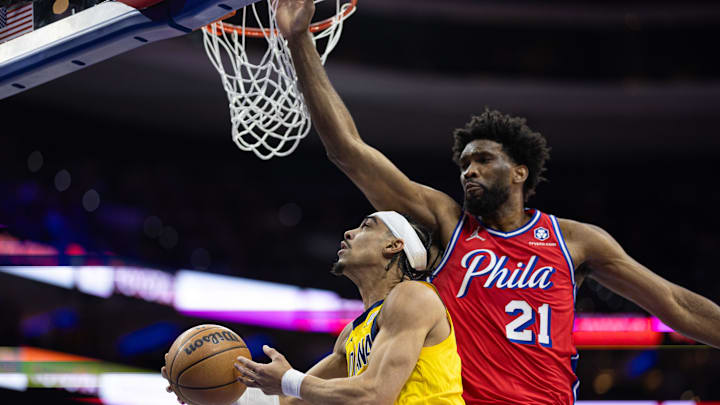 Dec 13, 2024; Philadelphia, Pennsylvania, USA; Indiana Pacers guard Andrew Nembhard (2) drives for a shot against Philadelphia 76ers center Joel Embiid (21) during the first quarter at Wells Fargo Center. Mandatory Credit: Bill Streicher-Imagn Images Dec 13, 2024; Philadelphia, Pennsylvania, USA; Indiana Pacers guard Andrew Nembhard (2) drives for a shot against Philadelphia 76ers center Joel Embiid (21) during the first quarter at Wells Fargo Center. Mandatory Credit: Bill Streicher-Imagn Images