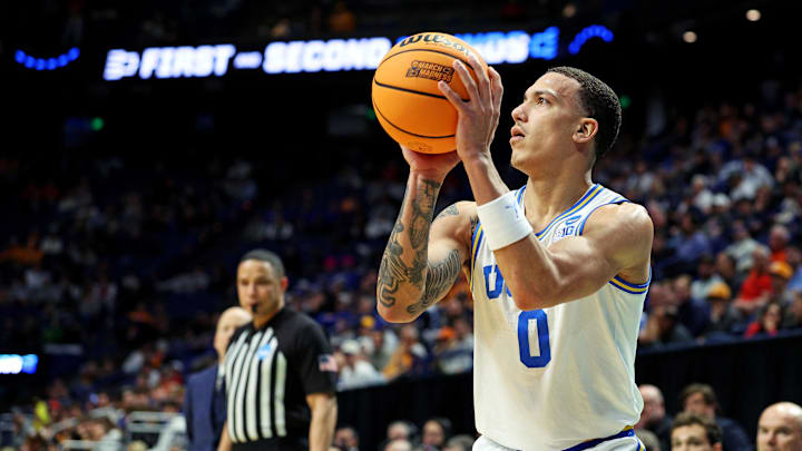 Mar 20, 2025; Lexington, KY, USA; UCLA Bruins guard Kobe Johnson (0) shoots the ball during the second half against the Utah State Aggies in the first round of the NCAA Tournament at Rupp Arena. Mandatory Credit: Jordan Prather-Imagn Images Mar 20, 2025; Lexington, KY, USA; UCLA Bruins guard Kobe Johnson (0) shoots the ball during the second half against the Utah State Aggies in the first round of the NCAA Tournament at Rupp Arena. Mandatory Credit: Jordan Prather-Imagn Images