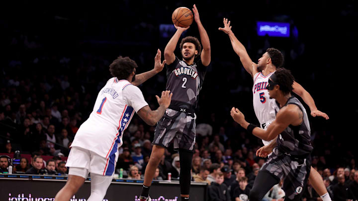 Feb 12, 2025; Brooklyn, New York, USA; Brooklyn Nets forward Cameron Johnson (2) takes a shot against Philadelphia 76ers center Andre Drummond (1) and guard Quentin Grimes (5) during the second quarter at Barclays Center. Mandatory Credit: Brad Penner-Imagn Images
