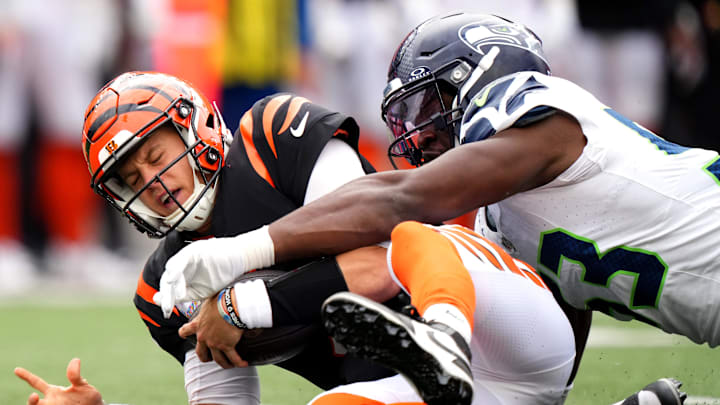 Cincinnati Bengals quarterback Joe Burrow (9) is sacked by Seattle Seahawks linebacker Boye Mafe (53) in the fourth quarter during an NFL football game between the Seattle Seahawks and the Cincinnati Bengals Sunday, Oct. 15, 2023, at Paycor Stadium in Cincinnati. The Cincinnati Bengals won, 17-13. Cincinnati Bengals quarterback Joe Burrow (9) is sacked by Seattle Seahawks linebacker Boye Mafe (53) in the fourth quarter during an NFL football game between the Seattle Seahawks and the Cincinnati Bengals Sunday, Oct. 15, 2023, at Paycor Stadium in Cincinnati. The Cincinnati Bengals won, 17-13.