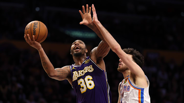 Feb 9, 2026; Los Angeles, California, USA;  Los Angeles Lakers guard Marcus Smart (36) shoots the ball against Oklahoma City Thunder center Chet Holmgren (7) during the fourth quarter at Crypto.com Arena. Mandatory Credit: Kiyoshi Mio-Imagn Images