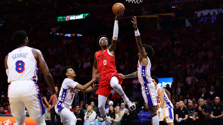 Nov 18, 2024; Miami, Florida, USA; Miami Heat guard Josh Richardson (0) drives to the basket past Philadelphia 76ers guard Jeff Dowtin Jr. (11) and guard Jared McCain (20) during the first quarter at Kaseya Center. Mandatory Credit: Sam Navarro-Imagn Images