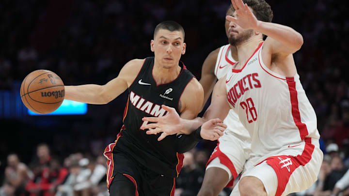Mar 21, 2025; Miami, Florida, USA;  Miami Heat guard Tyler Herro (14) drives to the basket as Houston Rockets center Alperen Sengun (28) defends in the second half at Kaseya Center. Mandatory Credit: Jim Rassol-Imagn Images