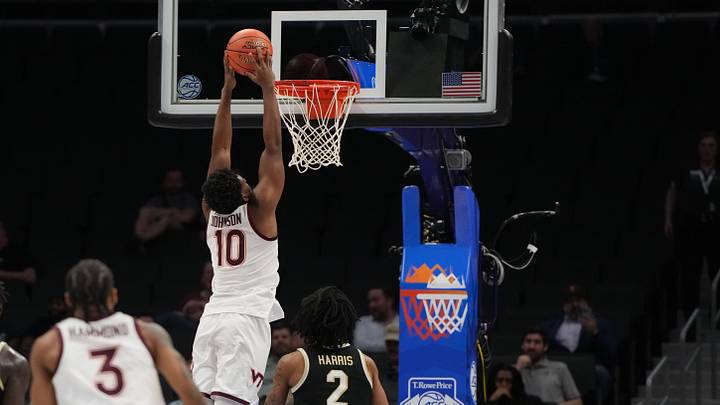 Mar 10, 2026; Charlotte, NC; Virginia Tech guard Tyler Johnson (10) scores as Wake Forest forward Juke Harris (2) defends.
