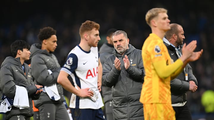Spurs players applaud the frustrated away supporters after the game