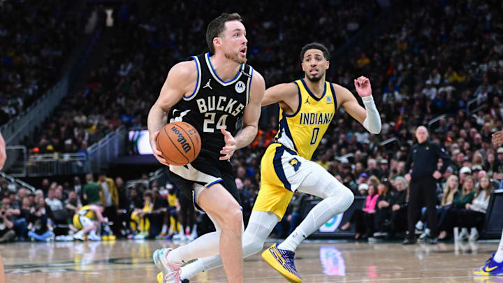 Apr 27, 2025; Milwaukee, Wisconsin, USA; Milwaukee Bucks guard Pat Connaughton (24) drives for the basket against Indiana Pacers guard Tyrese Haliburton (0) in the fourth quarter during game four of first round for the 2024 NBA Playoffs at Fiserv Forum. Mandatory Credit: Benny Sieu-Imagn Images