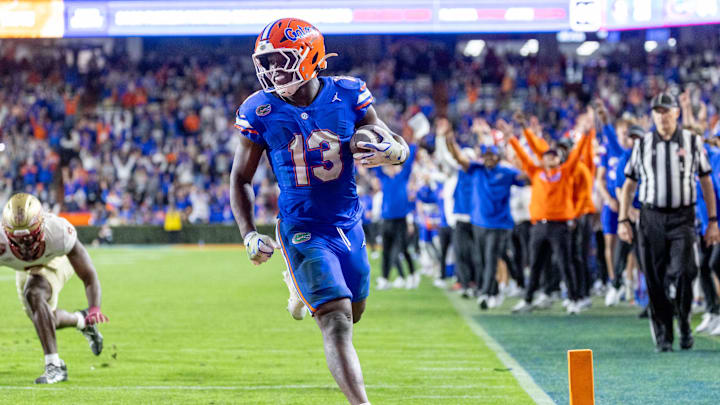Nov 29, 2025; Gainesville, Florida, USA; Florida Gators running back Jadan Baugh (13) scores a touchdown during the fourth quarter against the Florida State Seminoles at Ben Hill Griffin Stadium. Mandatory Credit: Bob Kupbens-Imagn Images Nov 29, 2025; Gainesville, Florida, USA; Florida Gators running back Jadan Baugh (13) scores a touchdown during the fourth quarter against the Florida State Seminoles at Ben Hill Griffin Stadium. Mandatory Credit: Bob Kupbens-Imagn Images