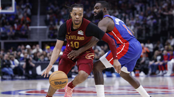Mar 28, 2025; Detroit, Michigan, USA;  Cleveland Cavaliers guard Darius Garland (10) dribbles defended by Detroit Pistons forward Tim Hardaway Jr. (8) in the second half at Little Caesars Arena. Mandatory Credit: Rick Osentoski-Imagn Images