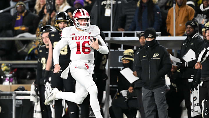 Nov 28, 2025; West Lafayette, Indiana, USA; Indiana Hoosiers quarterback Alberto Mendoza (16) rushes during the third quarter against the Purdue Boilermakers at Ross-Ade Stadium. Mandatory Credit: Marc Lebryk-Imagn Images