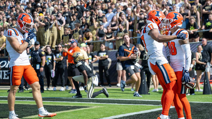 Oct 4, 2025; West Lafayette, Indiana, USA;  Illinois Fighting Illini wide receiver Hank Beatty (80) celebrates a touchdown with Illinois Fighting Illini wide receiver Collin Dixon (17) during the second quarter against the Purdue Boilermakers at Ross-Ade Stadium. Mandatory Credit: Marc Lebryk-Imagn Images