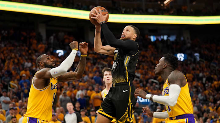 May 2, 2023; San Francisco, California, USA; Golden State Warriors guard Stephen Curry (30) drives to the hoop between Los Angeles Lakers forward LeBron James (6) and guard Dennis Schroder (17) in the fourth quarter during game one of the 2023 NBA playoffs at the Chase Center. 