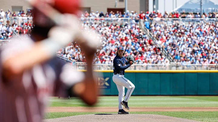 Jun 26, 2022; Omaha, NE, USA; Ole Miss pitcher Hunter Elliott (26) pitches while Oklahoma infielder Wallace Clark (6) waits during the first inning at Charles Schwab Field. Mandatory Credit: Jaylynn Nash-Imagn Images