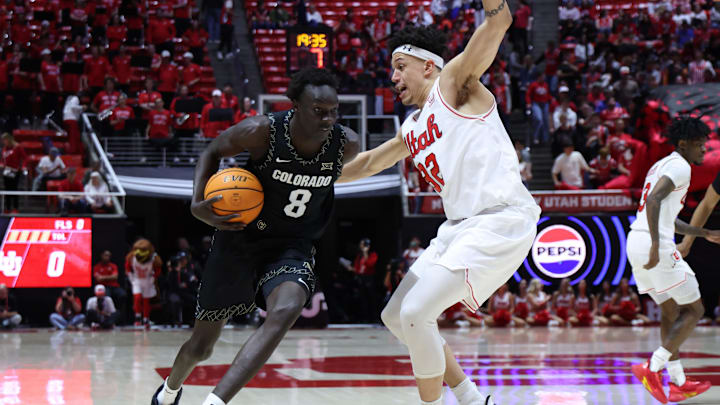 Mar 3, 2026; Salt Lake City, Utah, USA; Colorado Buffaloes forward Bangot Dak (8) drives against Utah Utes forward James Okonkwo (32) during the first half at Jon M. Huntsman Center. Mandatory Credit: Rob Gray-Imagn Images