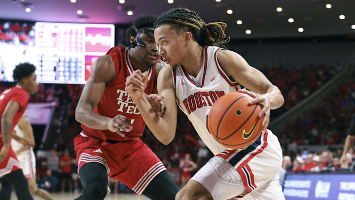 Jan 6, 2026; Houston, Texas, USA; Houston Cougars guard Kingston Flemings (4) drives with the ball as Texas Tech Red Raiders guard Jaylen Petty (11) defends during the second half at Fertitta Center. Mandatory Credit: Troy Taormina-Imagn Images