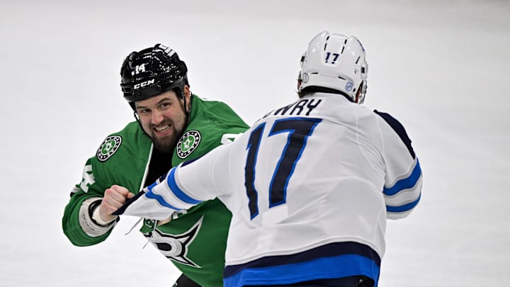 Apr 2, 2026; Dallas, Texas, USA; Dallas Stars left wing Jamie Benn (14) fights Winnipeg Jets center Adam Lowry (17) during the third period at the American Airlines Center. Mandatory Credit: Jerome Miron-Imagn Images