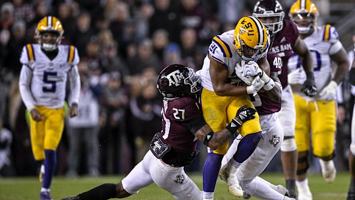 Nov 26, 2022; College Station, Texas, USA; Texas A&M Aggies defensive back Antonio Johnson (27) and LSU Tigers running back Noah Cain (21) in action during the game between the Texas A&M Aggies and the LSU Tigers at Kyle Field. Mandatory Credit: Jerome Miron-Imagn Images