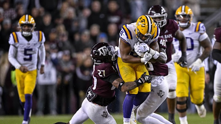 Nov 26, 2022; College Station, Texas, USA; Texas A&M Aggies defensive back Antonio Johnson (27) and LSU Tigers running back Noah Cain (21) in action during the game between the Texas A&M Aggies and the LSU Tigers at Kyle Field. Mandatory Credit: Jerome Miron-Imagn Images