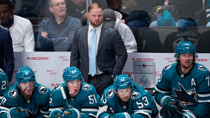 Oct 9, 2025; San Jose, California, USA; San Jose Sharks head coach Ryan Warsofsky watches game play against the Vegas Golden Knights with center Ty Dellandrea (10), right wing Collin Graf (51), left wing Jeff Skinner (53) and center Tyler Toffoli (73) during the second period at SAP Center at San Jose. Mandatory Credit: Robert Edwards-Imagn Images