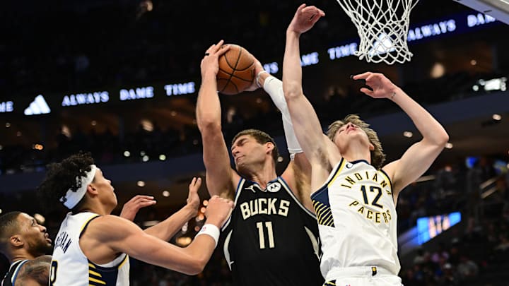 Nov 22, 2024; Milwaukee, Wisconsin, USA; Milwaukee Bucks center Brook Lopez (11) grabs a rebound against Indiana Pacers forward Enrique Freeman (8) and guard Johnny Furphy (12) in the second quarter at Fiserv Forum. Mandatory Credit: Benny Sieu-Imagn Images Nov 22, 2024; Milwaukee, Wisconsin, USA; Milwaukee Bucks center Brook Lopez (11) grabs a rebound against Indiana Pacers forward Enrique Freeman (8) and guard Johnny Furphy (12) in the second quarter at Fiserv Forum. Mandatory Credit: Benny Sieu-Imagn Images