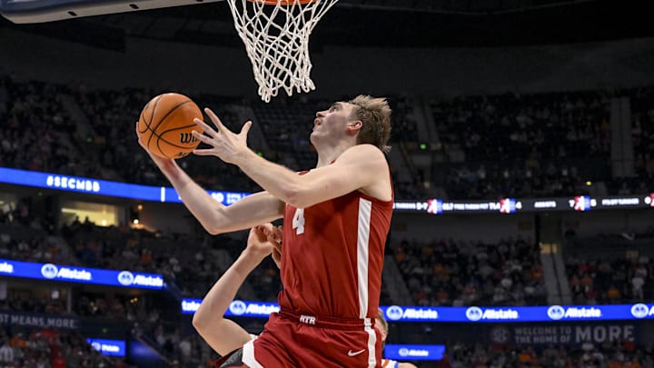 Mar 15, 2025; Nashville, TN, USA; Alabama Crimson Tide forward Grant Nelson (4) lays the ball in over Florida Gators forward Alex Condon (21) during the first half at Bridgestone Arena. Mandatory Credit: Steve Roberts-Imagn Images Mar 15, 2025; Nashville, TN, USA; Alabama Crimson Tide forward Grant Nelson (4) lays the ball in over Florida Gators forward Alex Condon (21) during the first half at Bridgestone Arena. Mandatory Credit: Steve Roberts-Imagn Images