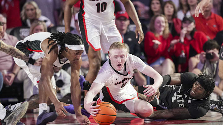 Feb 8, 2025; Athens, Georgia, USA; Georgia Bulldogs guards Silas Demary Jr. (5) and Blue Cain (0) fight for the ball with Mississippi State Bulldogs forward Cameron Matthews (4) during the first half at Stegeman Coliseum. Mandatory Credit: Dale Zanine-Imagn Images