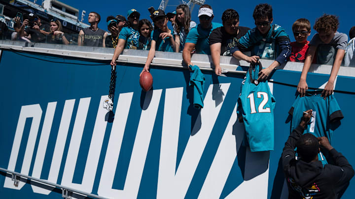 Jacksonville Jaguars wide receiver Travis Hunter (12) autographs a jersey before an NFL football game at EverBank Stadium, Sunday, Oct. 12, 2025, in Jacksonville, Fla.