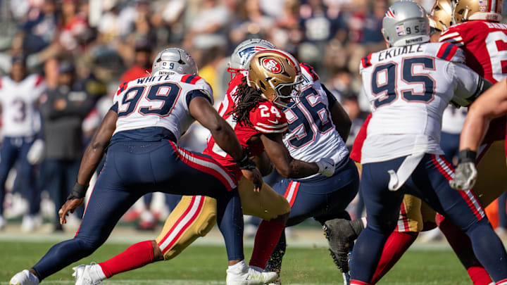 Sep 29, 2024; Santa Clara, California, USA; San Francisco 49ers running back Jordan Mason (24) runs with the football against New England Patriots defensive end Keion White (99) during the fourth quarter at Levi's Stadium.
