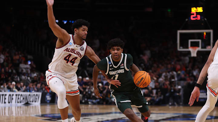 Michigan State Spartans guard Jase Richardson (11) drives against Auburn Tigers center Dylan Cardwell (44) during the second half in the South Regional final of the 2025 NCAA tournament at State Farm Arena. 