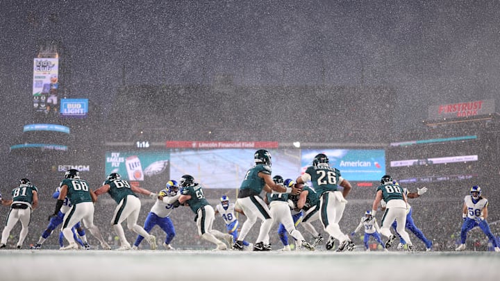 Jan 19, 2025; Philadelphia, Pennsylvania, USA; Philadelphia Eagles quarterback Jalen Hurts (1) hands the ball to Eagles running back Saquon Barkley (26) in the third quarter against the Los Angeles Rams in a 2025 NFC divisional round game at Lincoln Financial Field. Mandatory Credit: Bill Streicher-Imagn Images