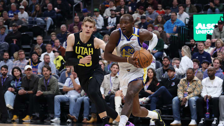 Oct 25, 2024; Salt Lake City, Utah, USA; Golden State Warriors forward Jonathan Kuminga (00) drives against Utah Jazz forward Lauri Markkanen (23) during the first quarter at Delta Center. Mandatory Credit: Rob Gray-Imagn Images