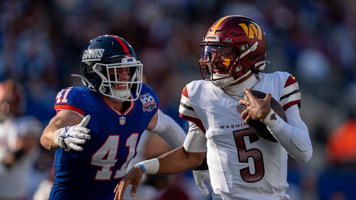 Washington Commanders quarterback Jayden Daniels (5) runs with the ball while being chased by New York Giants linebacker Micah McFadden (41) during a game between the New York Giants and the Washington Commanders at MetLife Stadium in East Rutherford on Sunday, Nov. 3, 2024.
