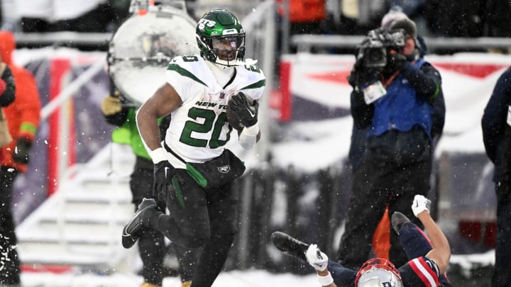 Jan 7, 2024; Foxborough, Massachusetts, USA; New York Jets running back Breece Hall (20) runs for a touchdown against the New England Patriots during the second half at Gillette Stadium.