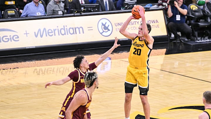 Jan 21, 2025; Iowa City, Iowa, USA; Iowa Hawkeyes forward Payton Sandfort (20) shoots the ball over Minnesota Golden Gophers guard Mike Mitchell Jr. (2) during the second half at Carver-Hawkeye Arena. Mandatory Credit: Jeffrey Becker-Imagn Images Jan 21, 2025; Iowa City, Iowa, USA; Iowa Hawkeyes forward Payton Sandfort (20) shoots the ball over Minnesota Golden Gophers guard Mike Mitchell Jr. (2) during the second half at Carver-Hawkeye Arena. Mandatory Credit: Jeffrey Becker-Imagn Images