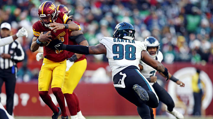 Washington Commanders quarterback Jayden Daniels breaks a tackle by Philadelphia Eagles defensive tackle Jalen Carter. Washington Commanders quarterback Jayden Daniels breaks a tackle by Philadelphia Eagles defensive tackle Jalen Carter.