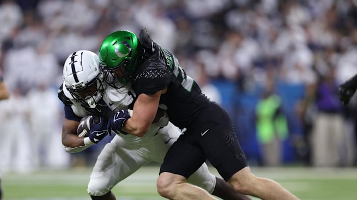 Dec 7, 2024; Indianapolis, IN, USA; Penn State Nittany Lions running back Nicholas Singleton (10) is tackled by Oregon Ducks linebacker Bryce Boettcher (28) during the second quarter in the 2024 Big Ten Championship game at Lucas Oil Stadium. Mandatory Credit: Jordan Prather-Imagn Images