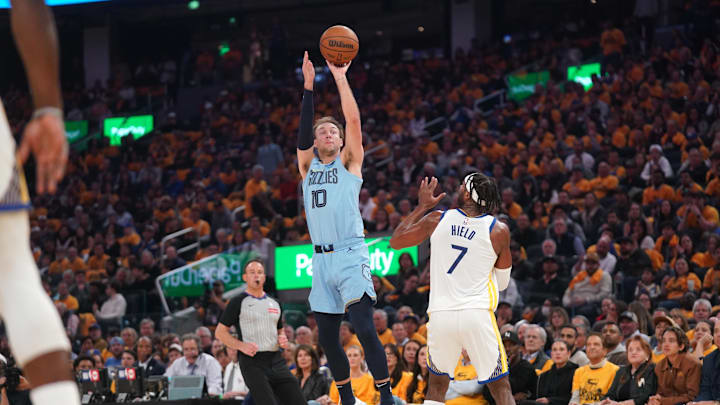 Apr 15, 2025; San Francisco, California, USA; Memphis Grizzlies guard Luke Kennard (10) makes a three-point basket over Golden State Warriors guard Buddy Hield (7) in the first quarter at the Chase Center. Mandatory Credit: Cary Edmondson-Imagn Images