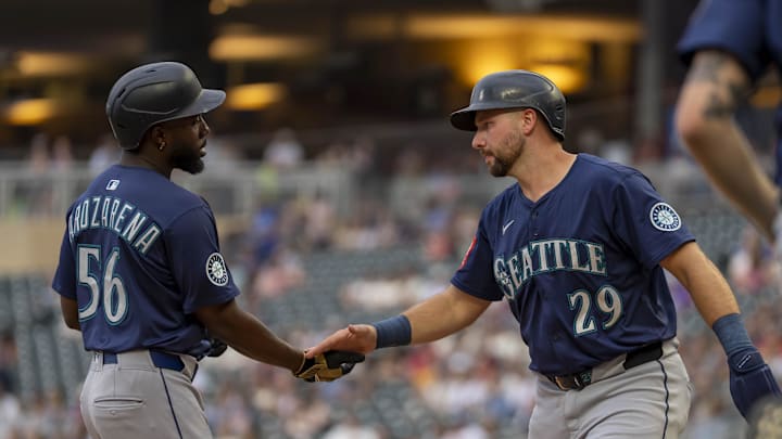 Seattle Mariners catcher Cal Raleigh (29) and left fielder Randy Arozarena (56) celebrate scoring runs against the Minnesota Twins in the third inning at Target Field on June 24. 