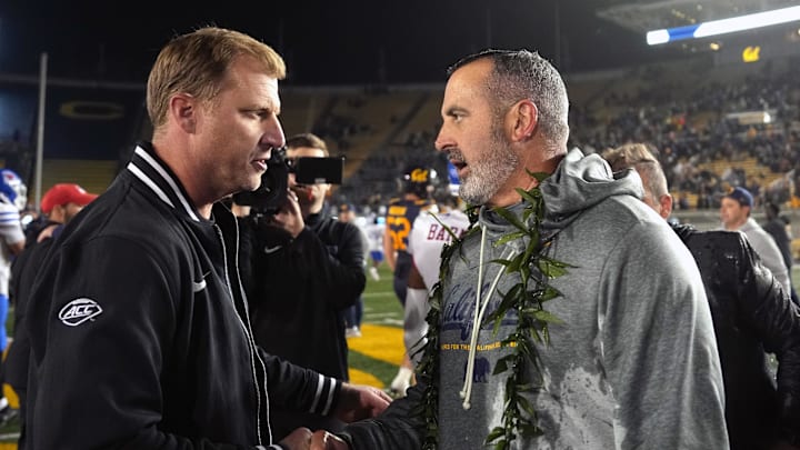 Cal interim head coach Nick Rolovich (right) shakes hands with SMU head coach Rhett Lashlee after the Bears victory over the 21st-ranked Mustangs