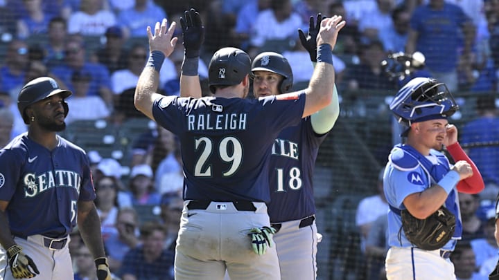 Jun 20, 2025; Chicago, Illinois, USA;  Seattle Mariners designated hitter Mitch Garver (18) celebrates his  three run home run against the Chicago Cubs with  catcher Cal Raleigh (29) during the ninth inning at Wrigley Field. Mandatory Credit: Matt Marton-Imagn Images