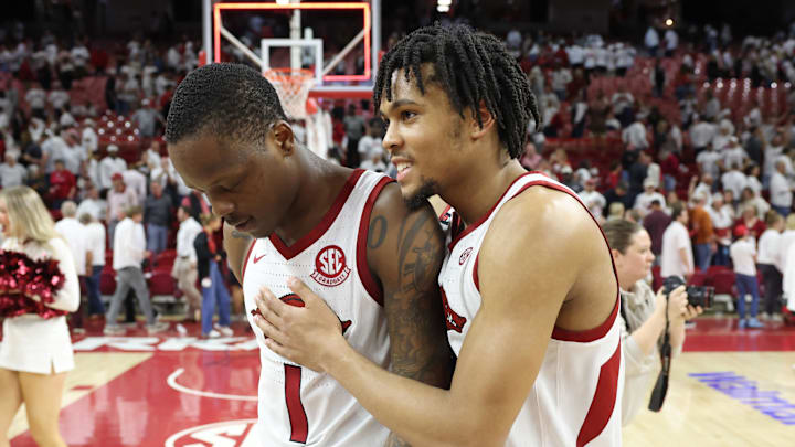 Feb 26, 2025; Fayetteville, Arkansas, USA; Arkansas Razorbacks guards Johnell Davis (1) and D.J. Wagner (21) celebrate after an overtime win against the Texas Longhorns at Bud Walton Arena. Mandatory Credit: Nelson Chenault-Imagn Images