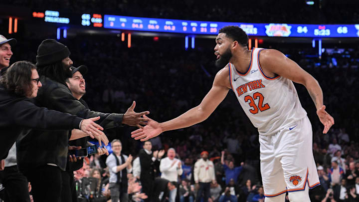 Dec 5, 2024; New York, New York, USA; New York Knicks center Karl-Anthony Towns (32) slaps hands with fans during the second half against the Charlotte Hornets at Madison Square Garden. Mandatory Credit: John Jones-Imagn Images