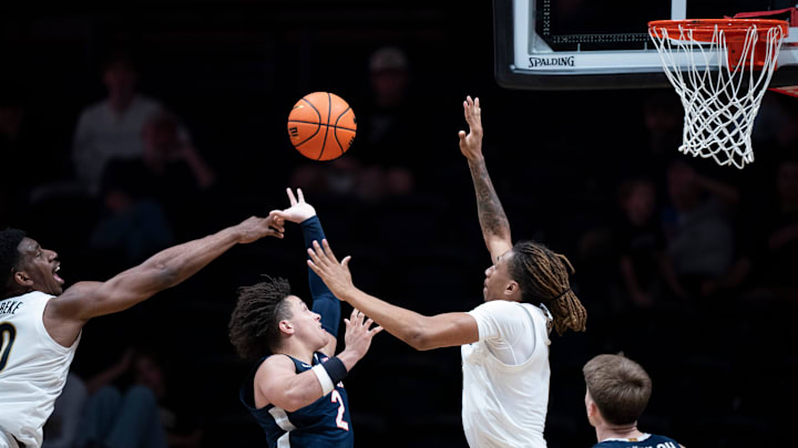 Virginia guard Chance Mallory (2) between Vanderbilt forward Tyler Harris (8) and forward AK Okereke (10) during the second half of their exhibition game at Memorial Gym in Nashville, Tenn., Thursday, Oct. 16, 2025.