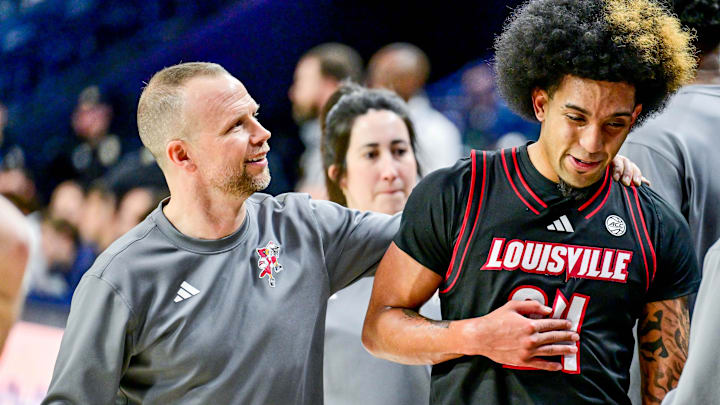 Feb 16, 2025; South Bend, Indiana, USA; Louisville Cardinals head coach Pat Kelsey talks to guard Chucky Hepburn (24) after he left the game against the Notre Dame Fighting Irish at the Purcell Pavilion. Louisville won 75-60. 