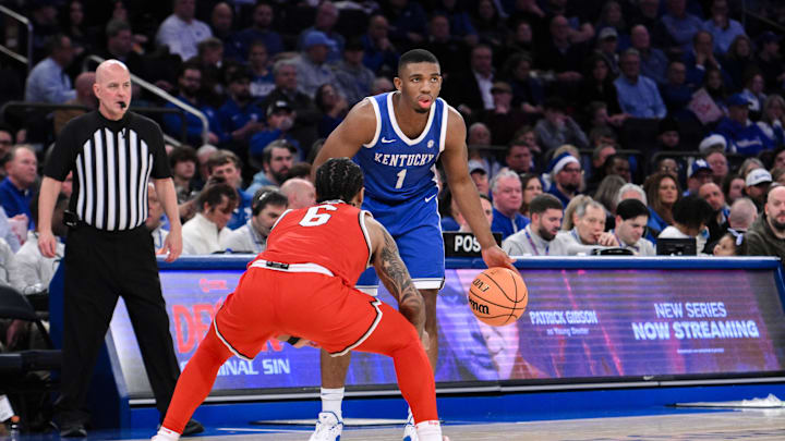 Dec 21, 2024; New York, New York, USA; Kentucky Wildcats guard Lamont Butler (1) sets the play while being defended by Ohio State Buckeyes guard Ques Glover (6) during the first half at Madison Square Garden. Mandatory Credit: John Jones-Imagn Images