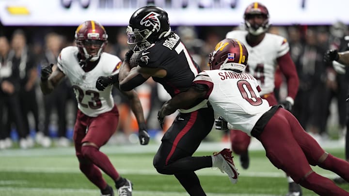 Atlanta Falcons running back Bijan Robinson scores a touchdown against Washington Commanders cornerback Mike Sainristil. Atlanta Falcons running back Bijan Robinson scores a touchdown against Washington Commanders cornerback Mike Sainristil.