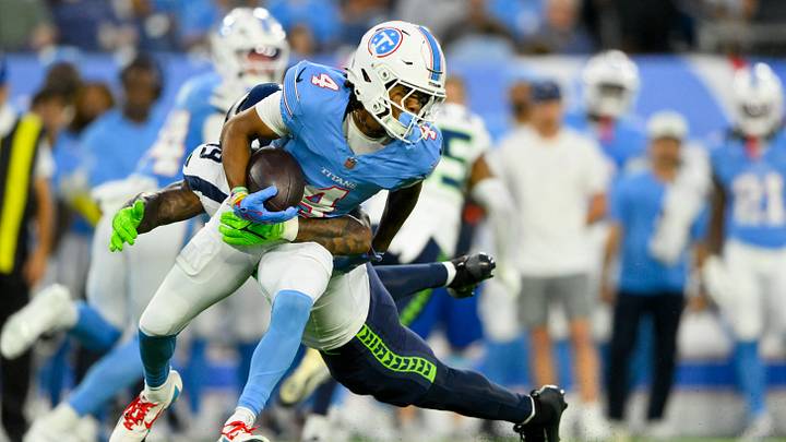 Aug 23, 2026; Nashville, Tennessee, USA;  Seattle Seahawks linebacker Chris Paul Jr. (49) tackles Tennessee Titans wide receiver Wan'Dale Robinson (4) after a made catch during the first half at Nissan Stadium.  Mandatory Credit: Steve Roberts-Imagn Images